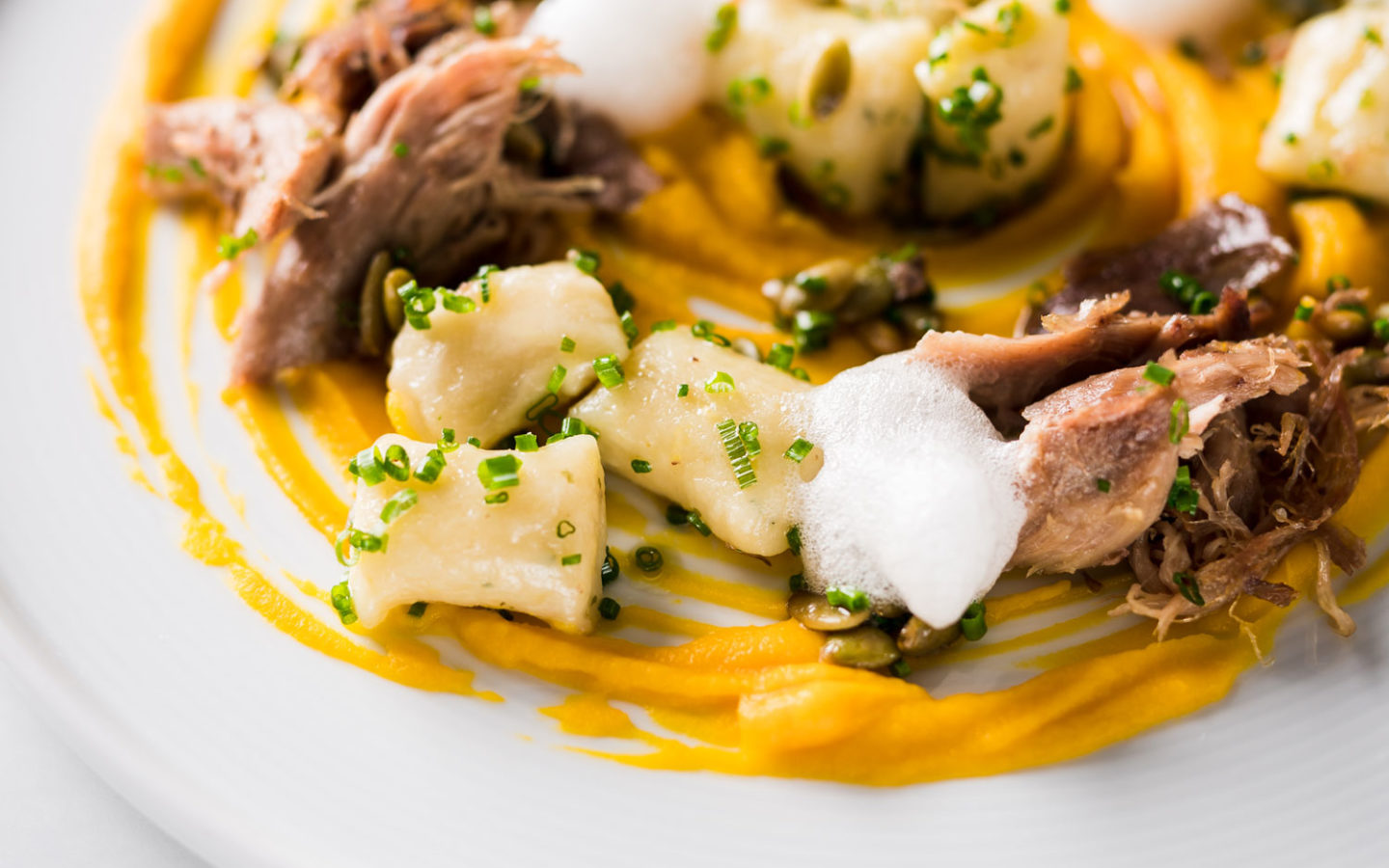 meat food with sauce artistically places on dinner plate